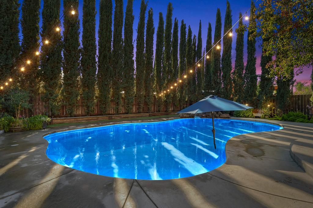 806 Mono Street Manteca, CA 95337 - Photo 3 of 38 a view of a swimming pool with an outdoor space and seating area
