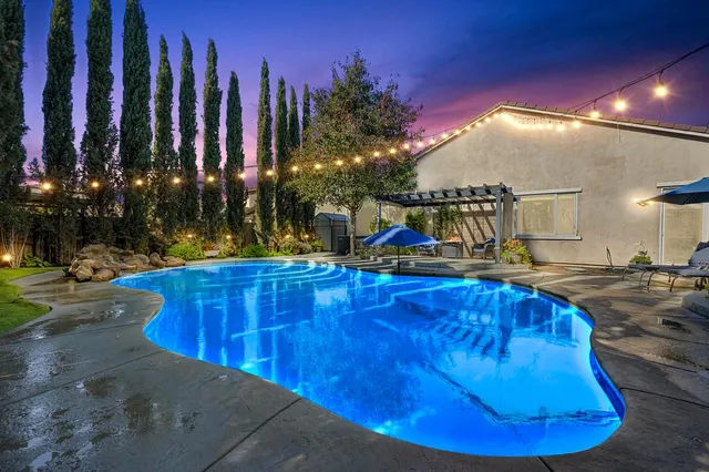 a view of a swimming pool with an outdoor space and seating area