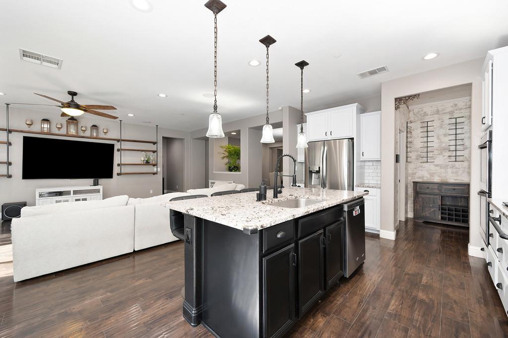 806 Mono Street Manteca, CA 95337 - Photo 7 of 38 a kitchen with stainless steel appliances kitchen island a large island in the center