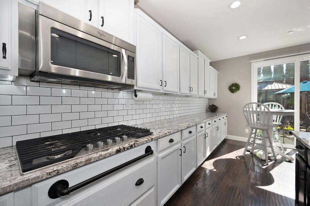 806 Mono Street Manteca, CA 95337 - Photo 8 of 38 a kitchen with granite countertop a stove and a microwave