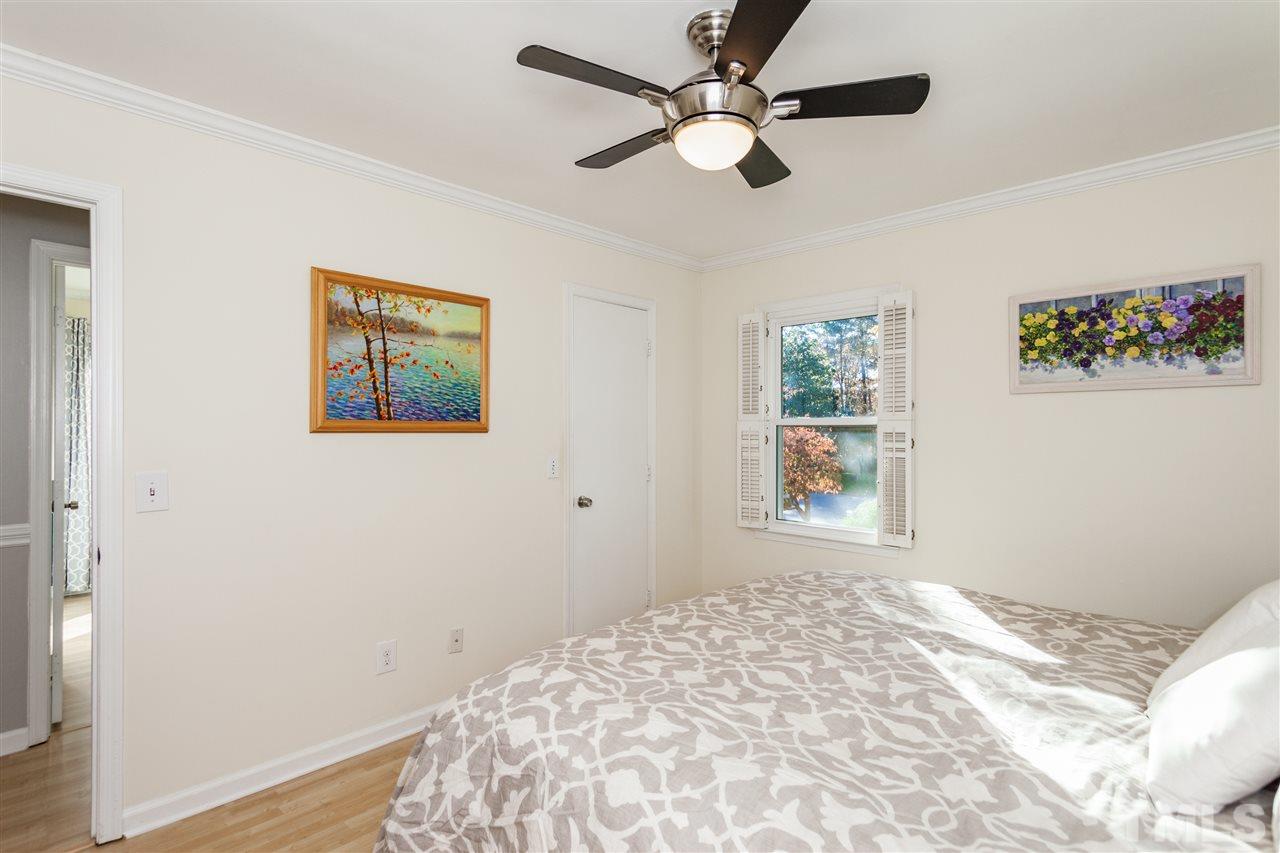 7709 Nugget Lane Raleigh, NC 27615 - Photo 14 of 25 a view of a bedroom with wooden floor and window