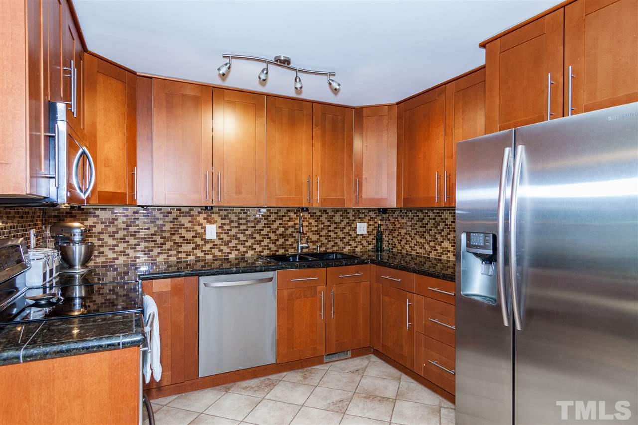7709 Nugget Lane Raleigh, NC 27615 - Photo 8 of 25 a kitchen with stainless steel appliances granite countertop a refrigerator and a sink