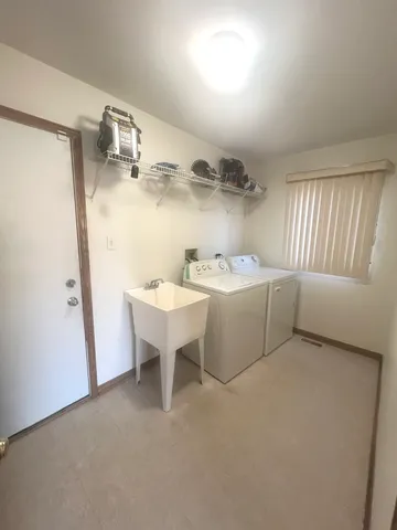 a view of a storage & utility room with two washing machine