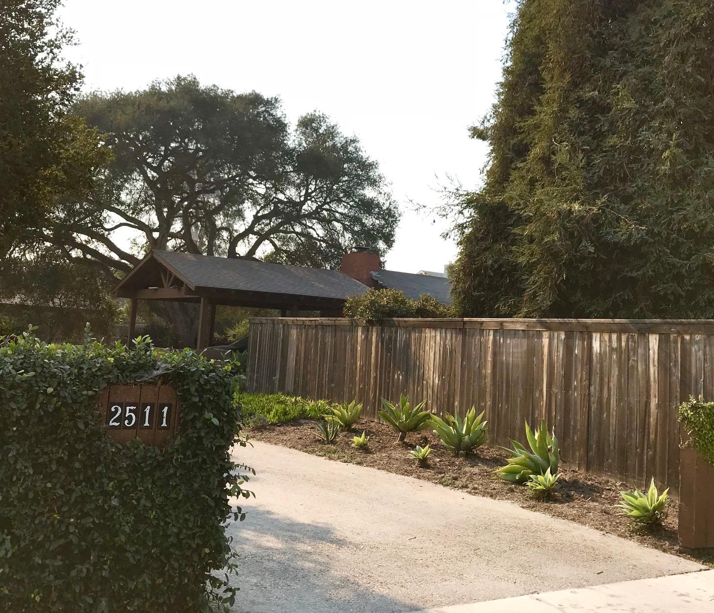 2511 Medcliff Road Santa Barbara, CA 93109 - Photo 4 of 8 a backyard of a house with potted plants and large tree