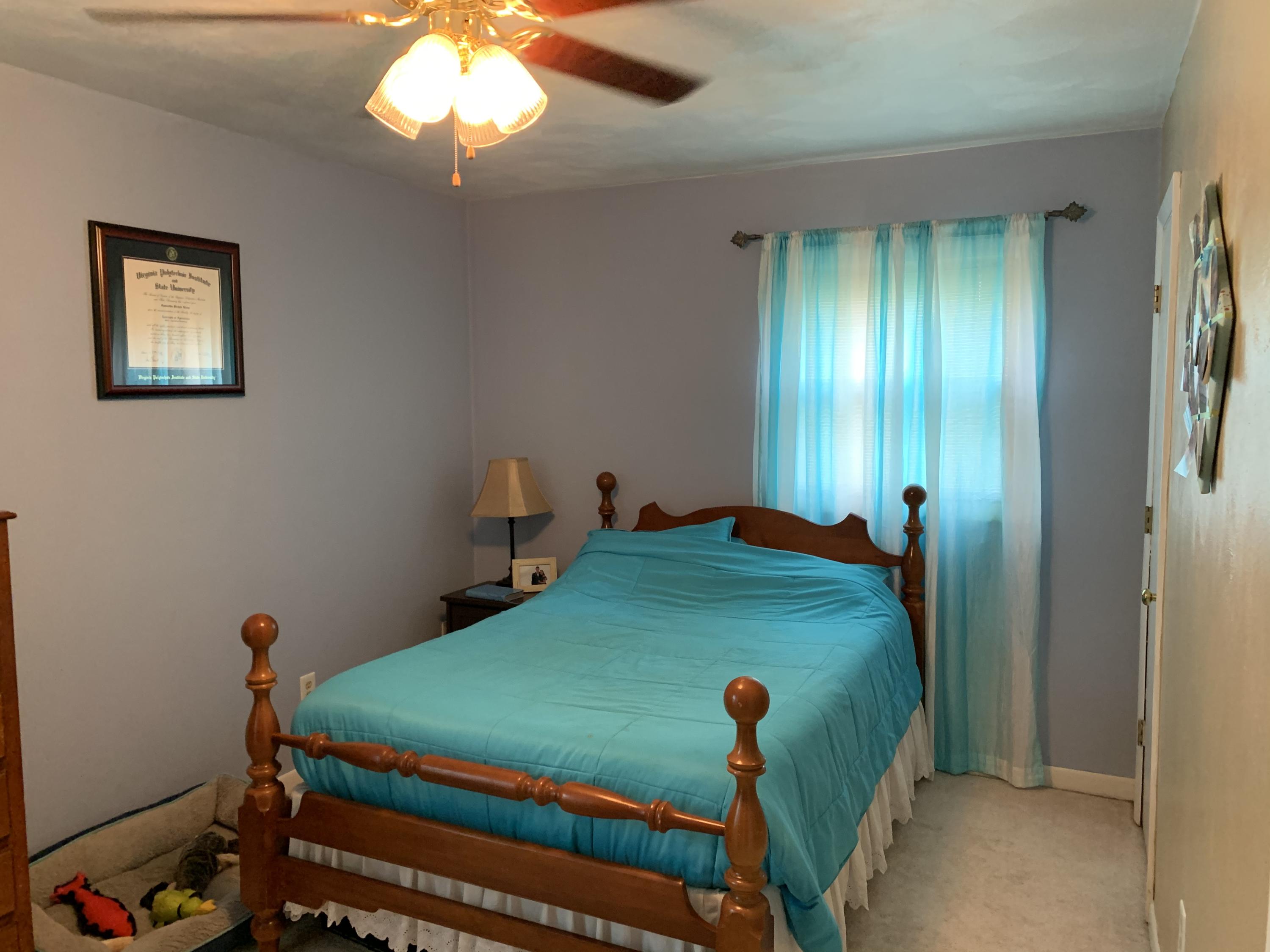691 Mountain Pass Road Blue Ridge, VA 24064 - Photo 5 of 13 a bed sitting in a bedroom next to a window