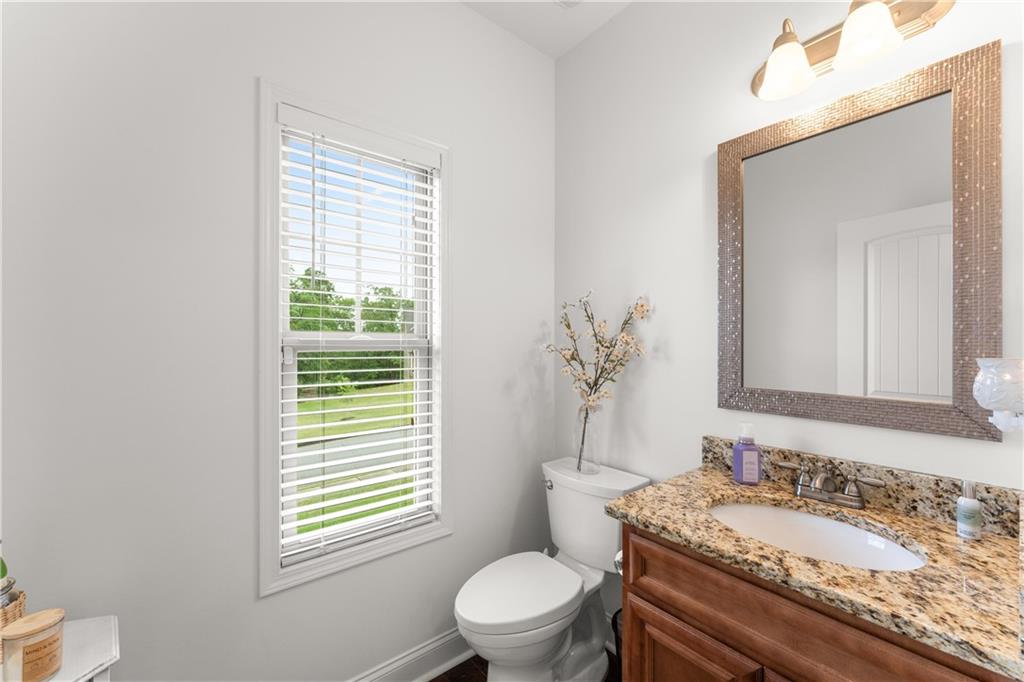 10 Coppage Lane Cartersville, GA 30120 - Photo 19 of 51 a bathroom with a granite countertop sink toilet a large mirror and a window