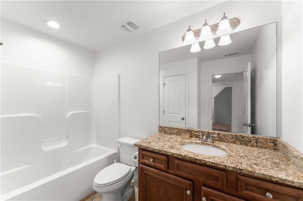10 Coppage Lane Cartersville, GA 30120 - Photo 34 of 51 a bathroom with a granite countertop sink a toilet and bathtub