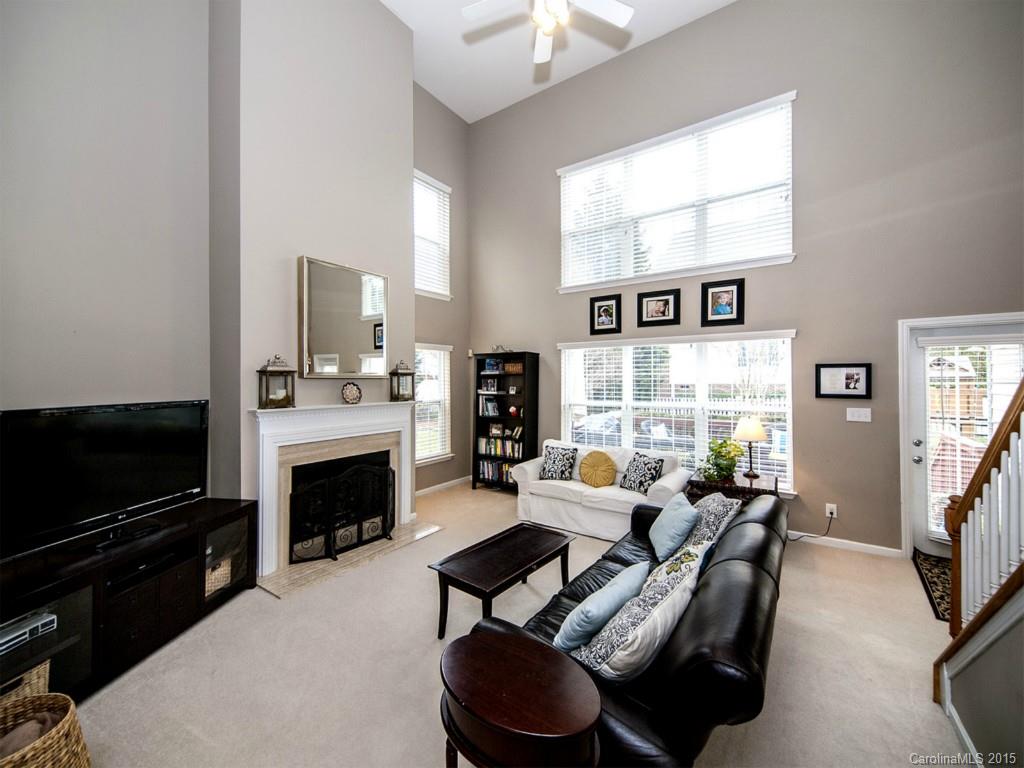 6509 Elfreda Road Charlotte, NC 28270 - Photo 3 of 19 a living room with furniture a flat screen tv and a fireplace