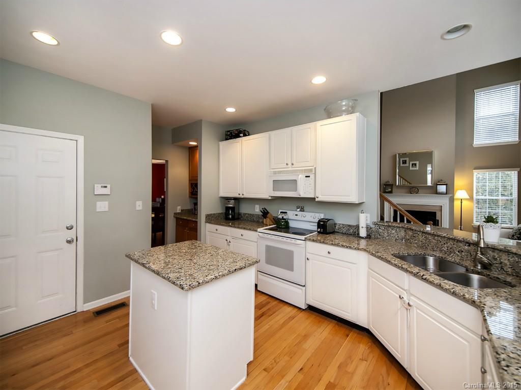 6509 Elfreda Road Charlotte, NC 28270 - Photo 6 of 19 a kitchen with granite countertop kitchen island a sink appliances and cabinets