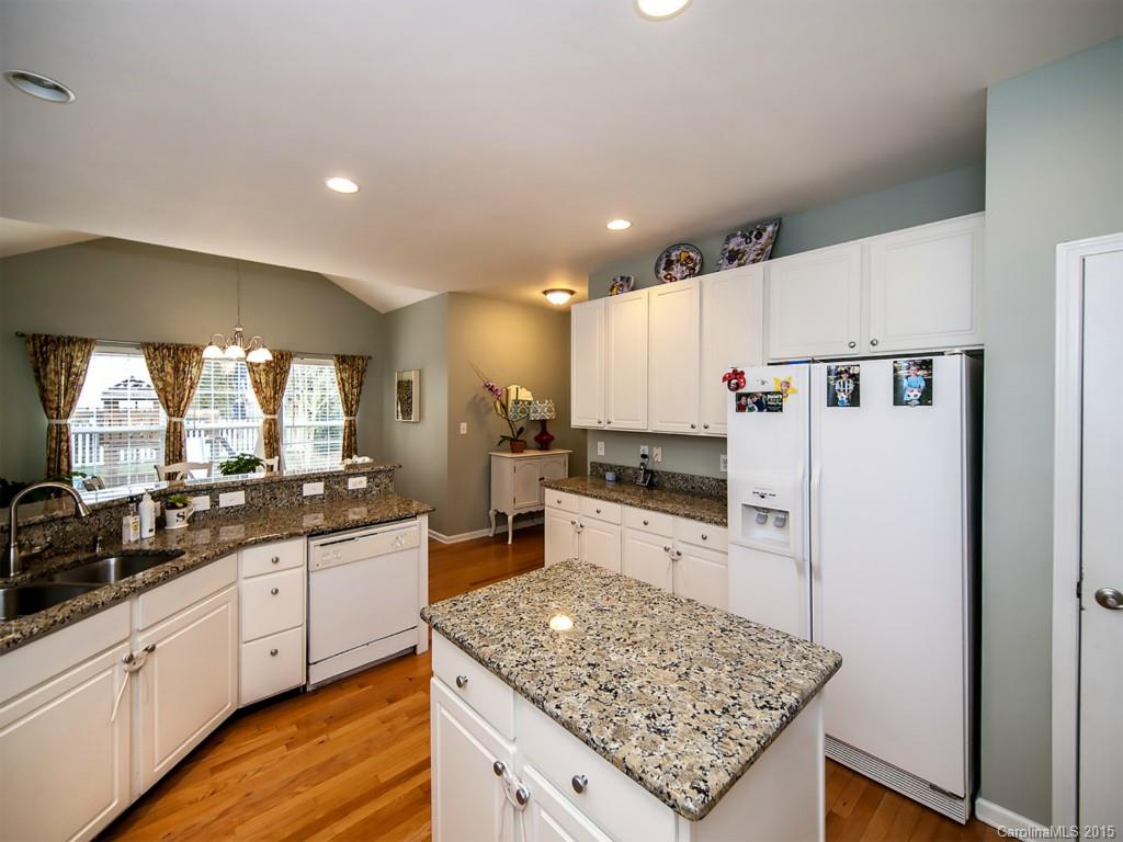 6509 Elfreda Road Charlotte, NC 28270 - Photo 7 of 19 a kitchen with stainless steel appliances kitchen island granite countertop a sink stove and refrigerator