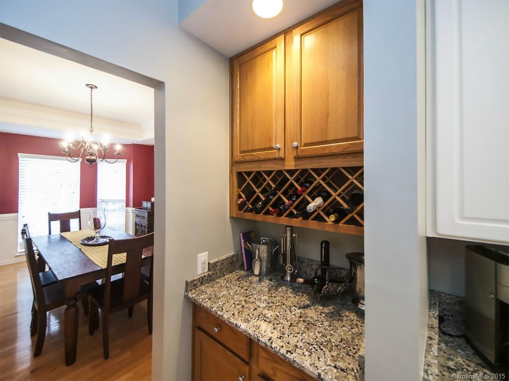 6509 Elfreda Road Charlotte, NC 28270 - Photo 9 of 19 a kitchen area with granite countertop a sink and a refrigerator