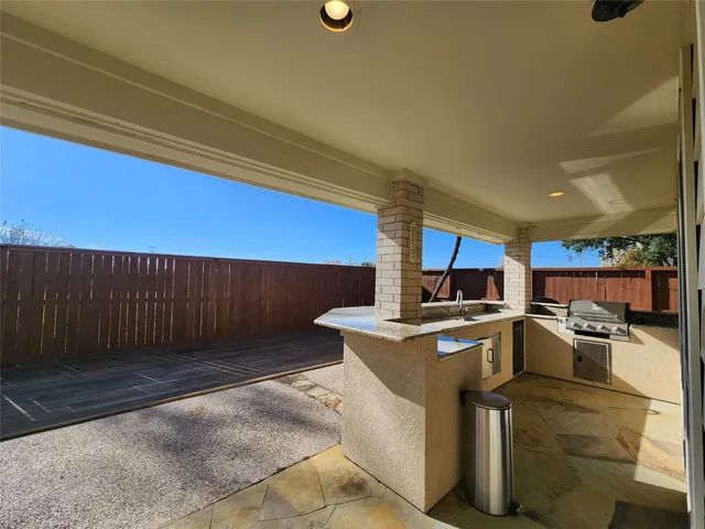 a view of a kitchen with a sink and dishwasher