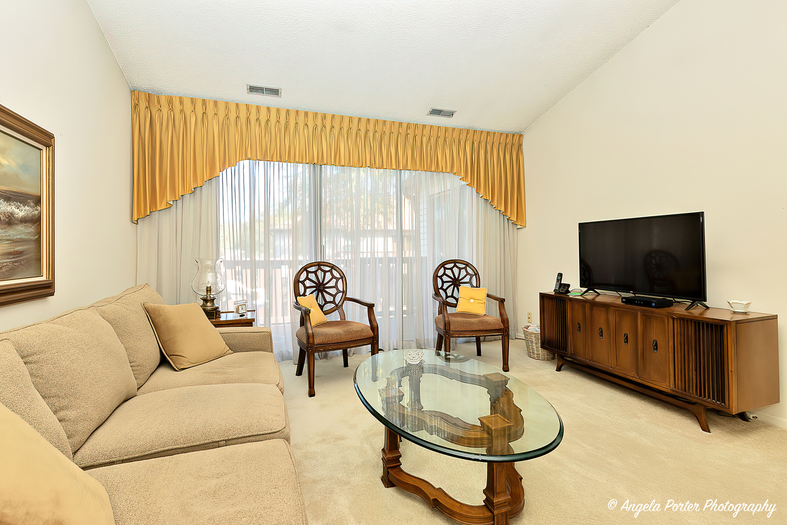 763 Weidner Road, Unit 8D2 Buffalo Grove, IL 60089 - Photo 3 of 22 a living room with furniture a flat screen tv and a window