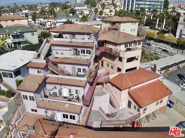 an aerial view of a residential apartment building with a yard