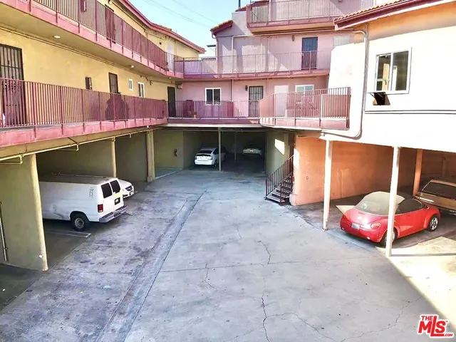 a backyard of a house with barbeque oven and chairs
