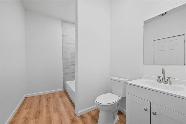 a bathroom with a sink a toilet and vanity