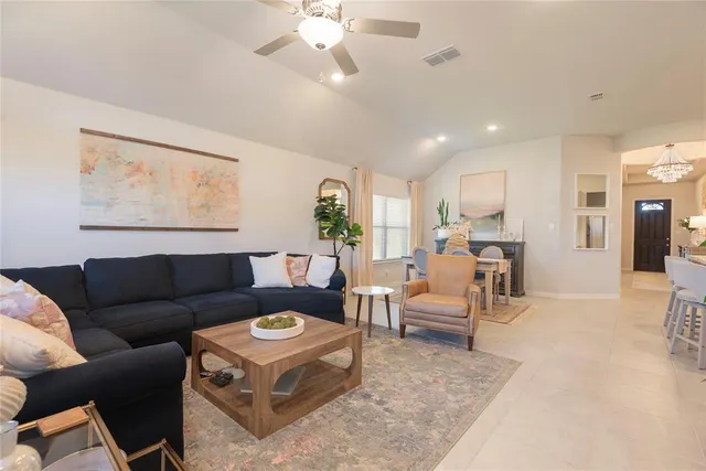 a living room with furniture and a large window