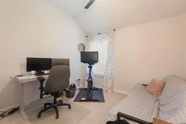 a bedroom with a bed and a chair in it