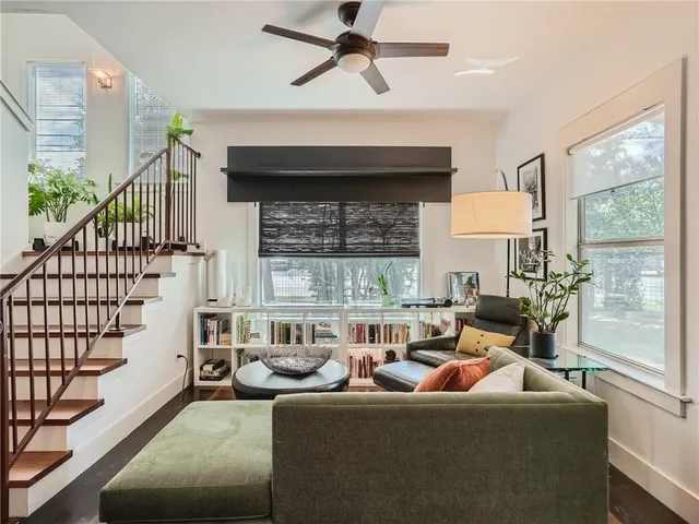 a living room with furniture fireplace and a large window