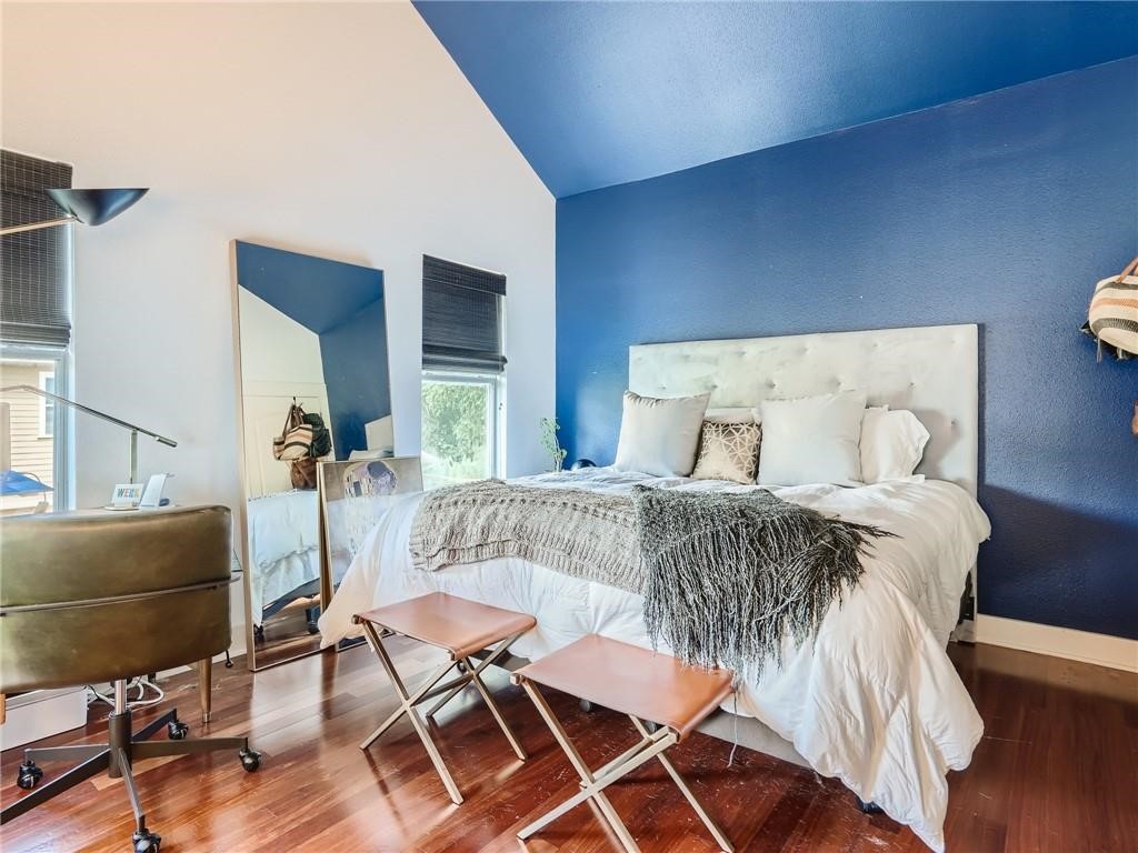 3304 East 5th Street, Unit A Austin, TX 78702 - Photo 10 of 16 a bedroom with a bed and wooden floor