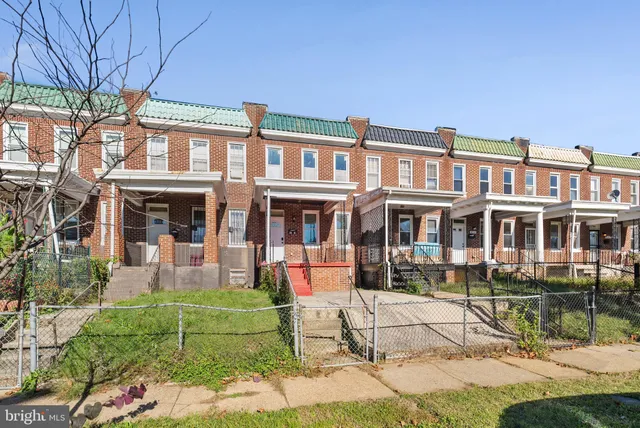 a front view of a house with a yard table and chairs