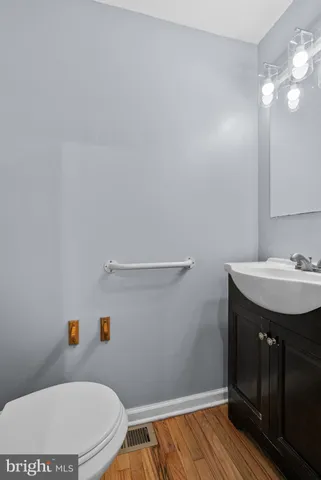 a bathroom with a sink a toilet and vanity