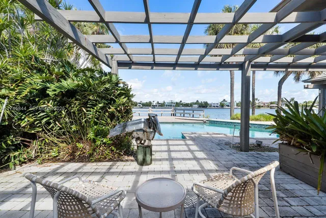 a patio with a table and chairs