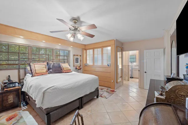 a bed room with a bed and a television