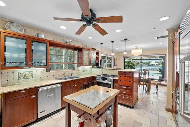 a kitchen with a table chairs sink and cabinets