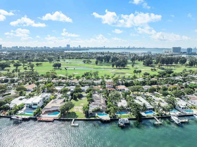 an aerial view of a houses with a yard