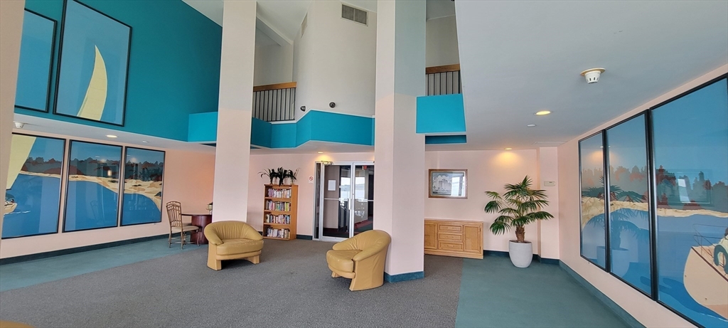 750 Davol Street, Unit 1012 Fall River, MA 02720 - Photo 17 of 29 a living room with furniture and a chandelier