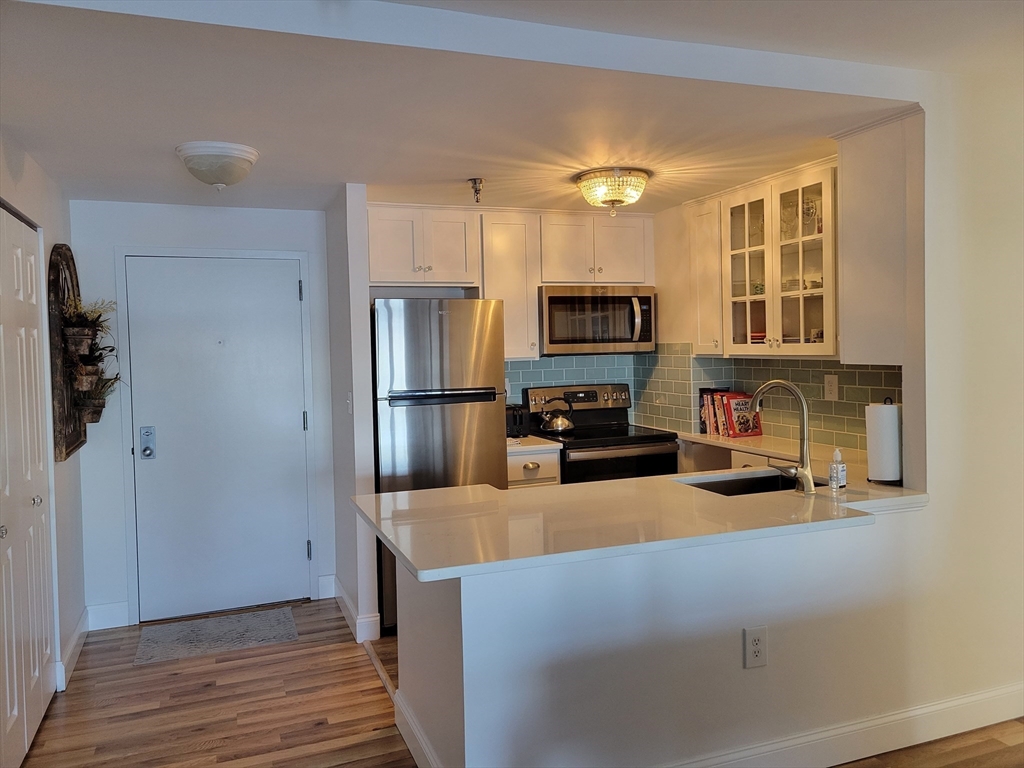 750 Davol Street, Unit 1012 Fall River, MA 02720 - Photo 7 of 29 a kitchen with stainless steel appliances a refrigerator sink and microwave