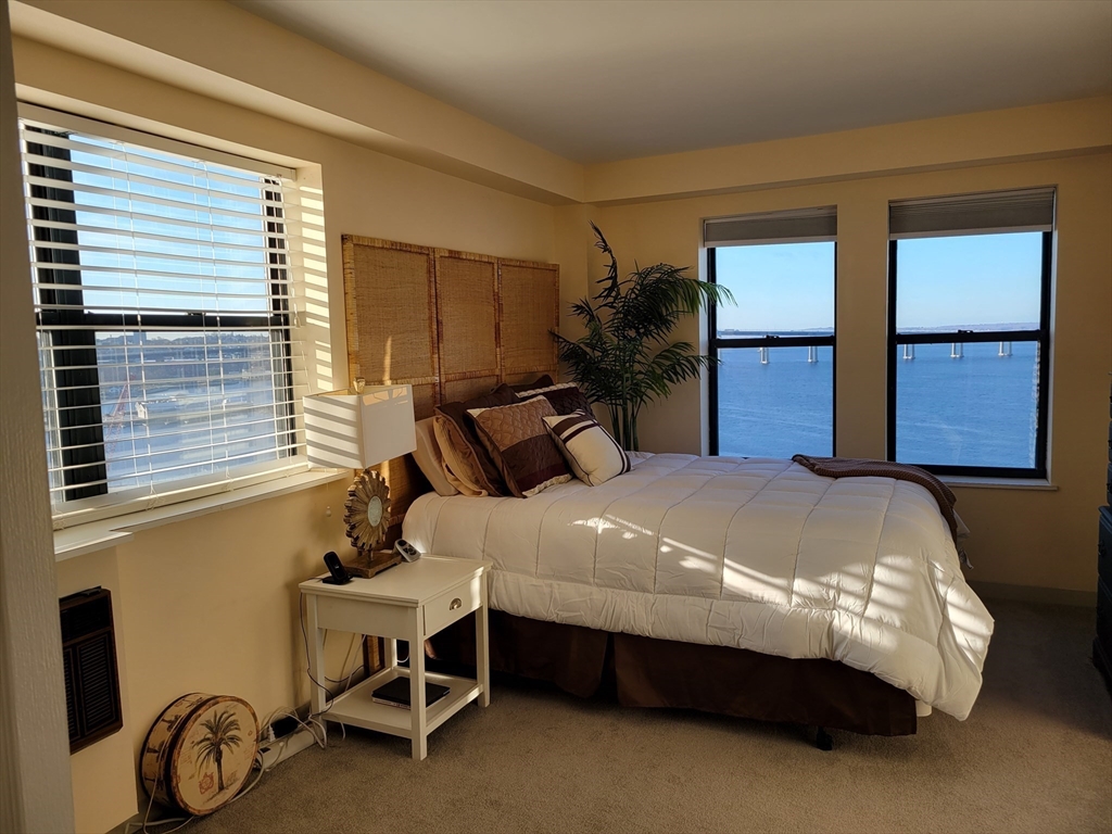 750 Davol Street, Unit 1012 Fall River, MA 02720 - Photo 10 of 29 a bed sitting in a bedroom next to a window