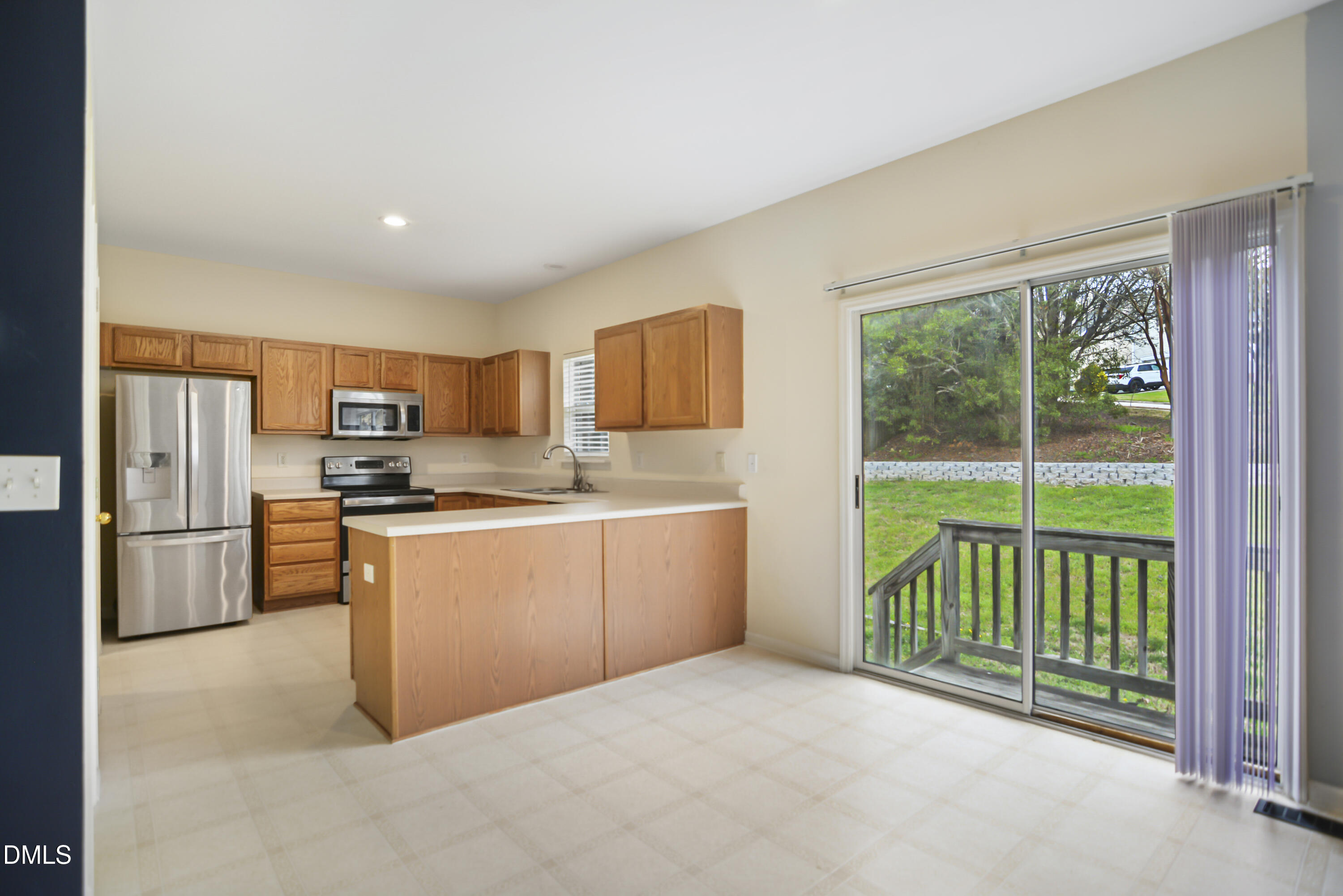 2241 Spruce Shadows Lane Raleigh, NC 27614 - Photo 10 of 29 a kitchen with a refrigerator and a sink