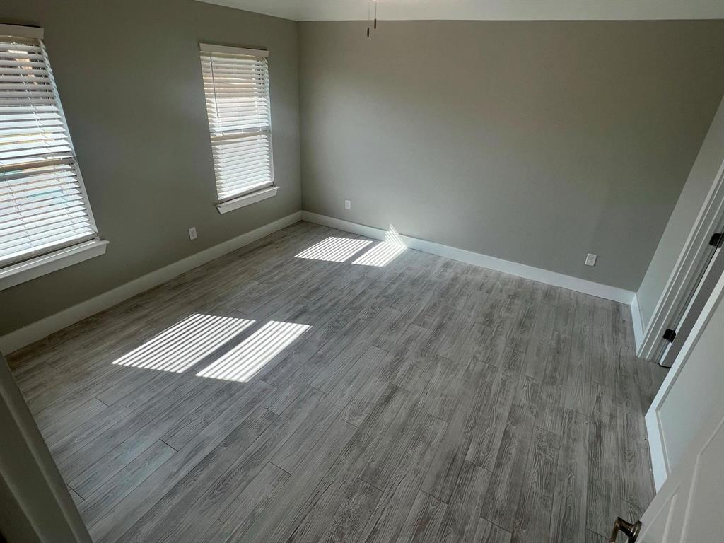 605 North Friendship Road Sherman, TX 75092 - Photo 14 of 17 an empty room with wooden floor and windows