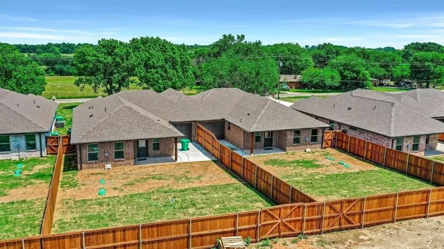 a kitchen with a refrigerator and a stove top oven