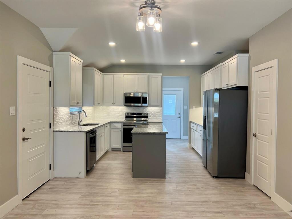 605 North Friendship Road Sherman, TX 75092 - Photo 17 of 17 a kitchen with a refrigerator and a stove top oven