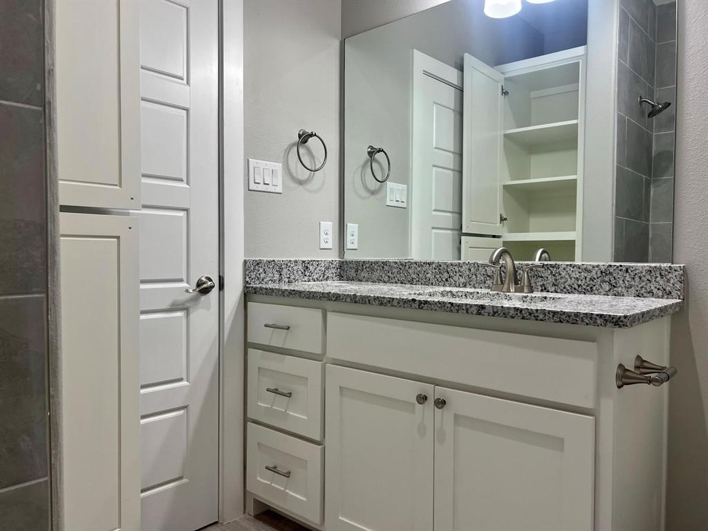 605 North Friendship Road Sherman, TX 75092 - Photo 2 of 17 a bathroom with a granite countertop sink and a mirror