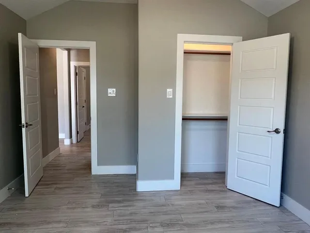 a view of a hallway with wooden floor