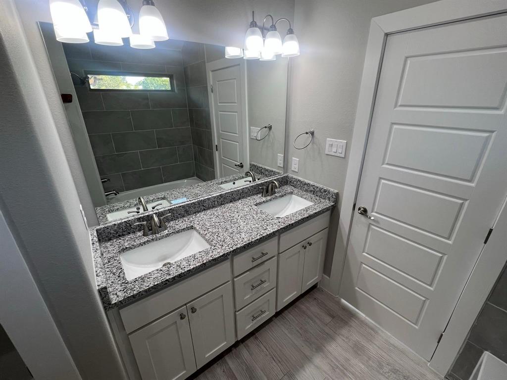 605 North Friendship Road Sherman, TX 75092 - Photo 5 of 17 a bathroom with a granite countertop sink toilet and shower