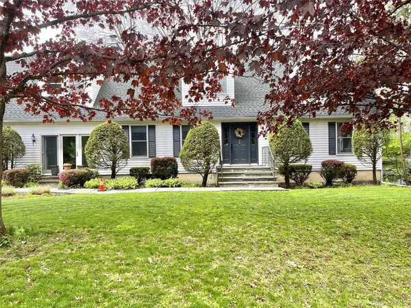 a view of a house with backyard porch and sitting area