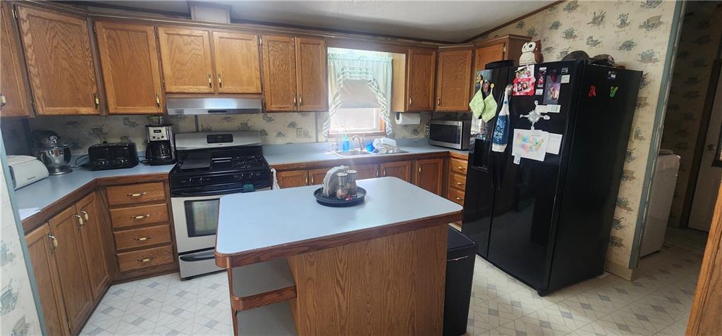 1374 Saltsburg Road Clarksburg, PA 15725 - Photo 10 of 22 a kitchen with a refrigerator and a stove top oven