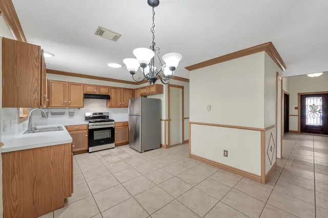 a kitchen with stainless steel appliances granite countertop a refrigerator sink and cabinets