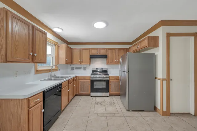 a kitchen with stainless steel appliances granite countertop a refrigerator and a sink