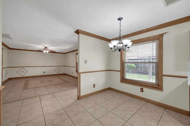 a view of a livingroom with a ceiling fan and window