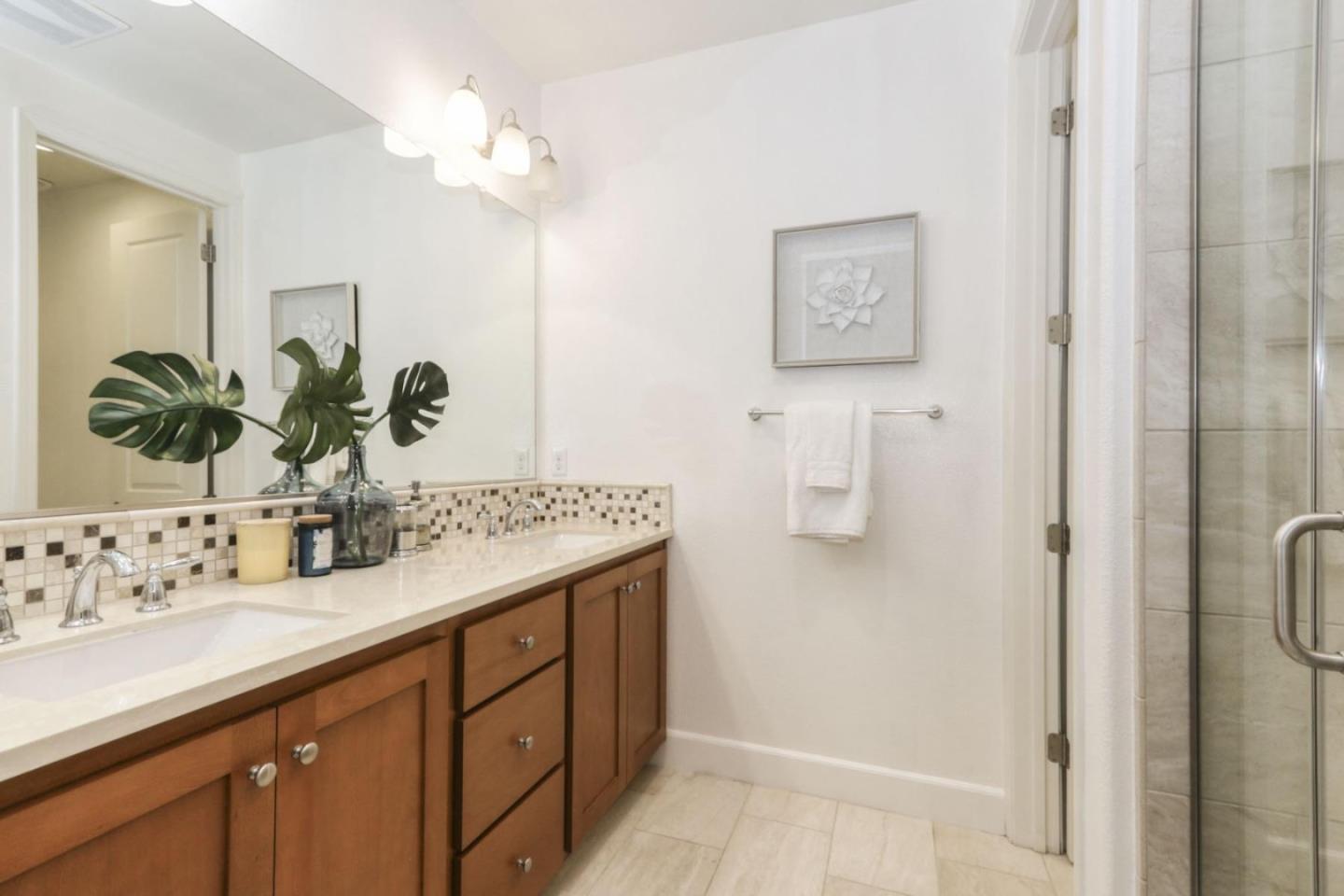 2043 Atlas Loop Mountain View, CA 94043 - Photo 12 of 42 a bathroom with a double vanity sink a mirror and shower