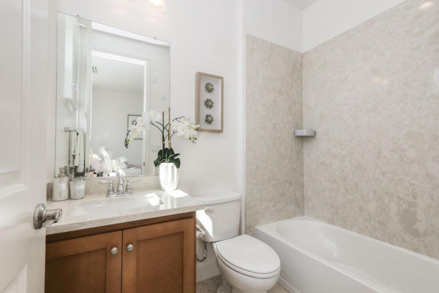 2043 Atlas Loop Mountain View, CA 94043 - Photo 17 of 42 a bathroom with a granite countertop sink a toilet and shower