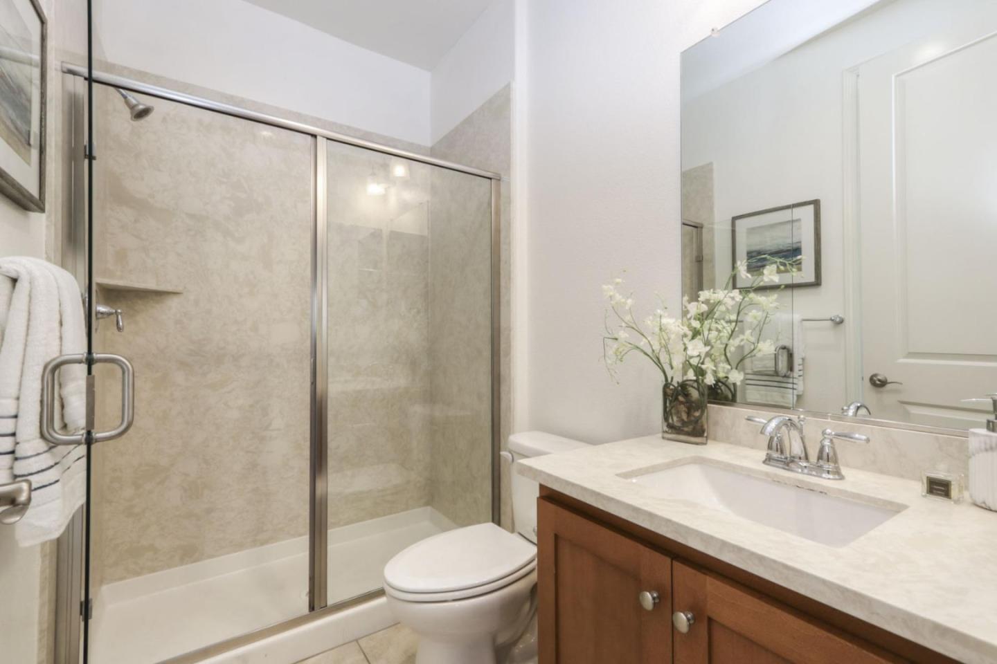 2043 Atlas Loop Mountain View, CA 94043 - Photo 19 of 42 a bathroom with a granite countertop sink toilet and shower