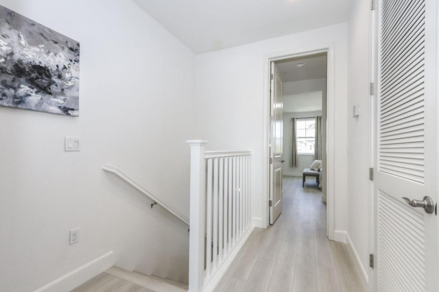 2043 Atlas Loop Mountain View, CA 94043 - Photo 29 of 42 a view of a hallway with a livingroom and a bathroom with sink