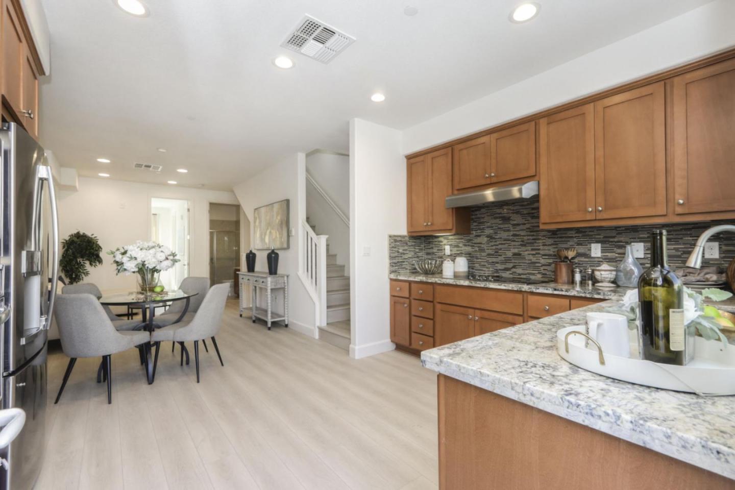 2043 Atlas Loop Mountain View, CA 94043 - Photo 5 of 42 a kitchen with stainless steel appliances granite countertop a stove a sink a refrigerator and chairs